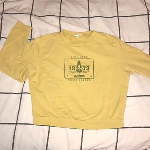 Yellow crew neck sweater.